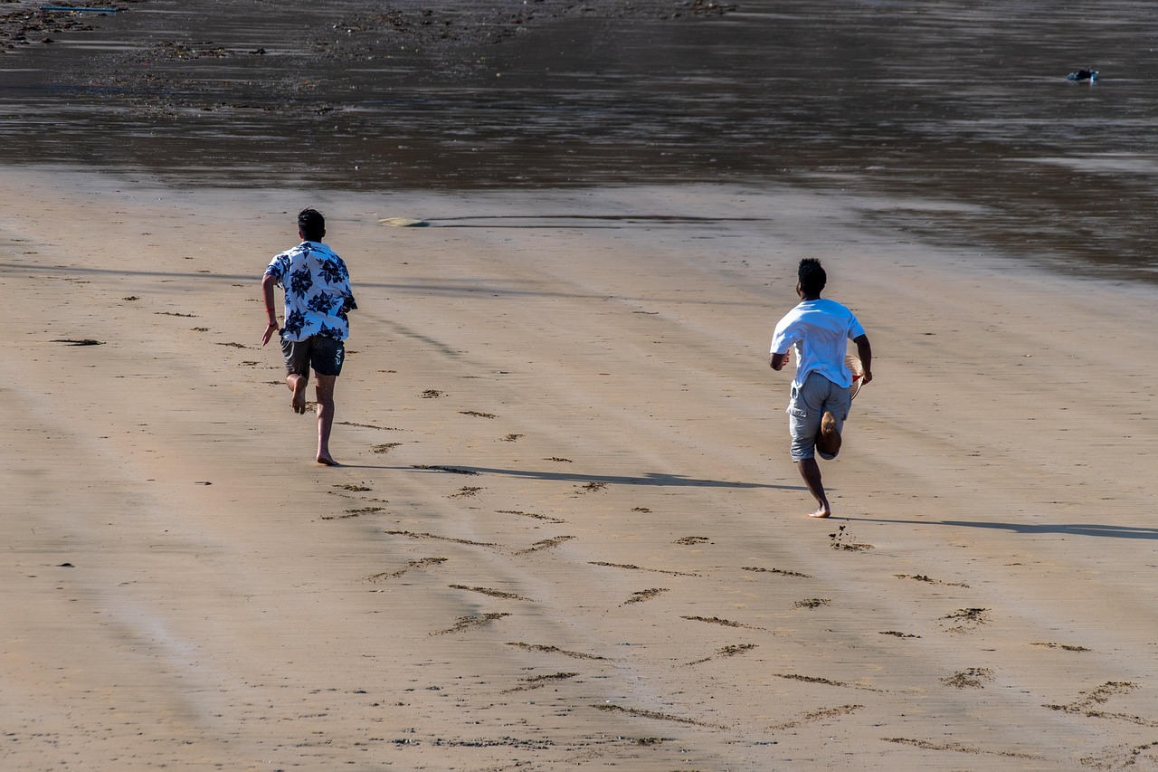 Runners sprinting along the shore