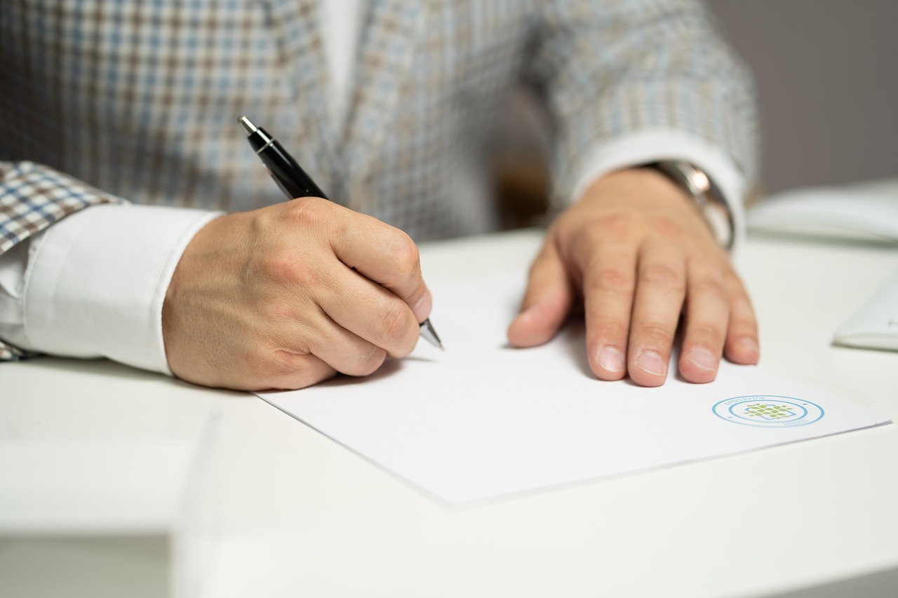 man signing contract, agreement
