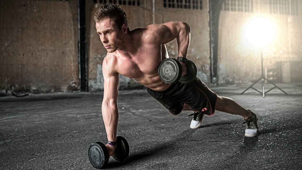 Services Man exercising in a gym, highlighting strength training and dedication.
