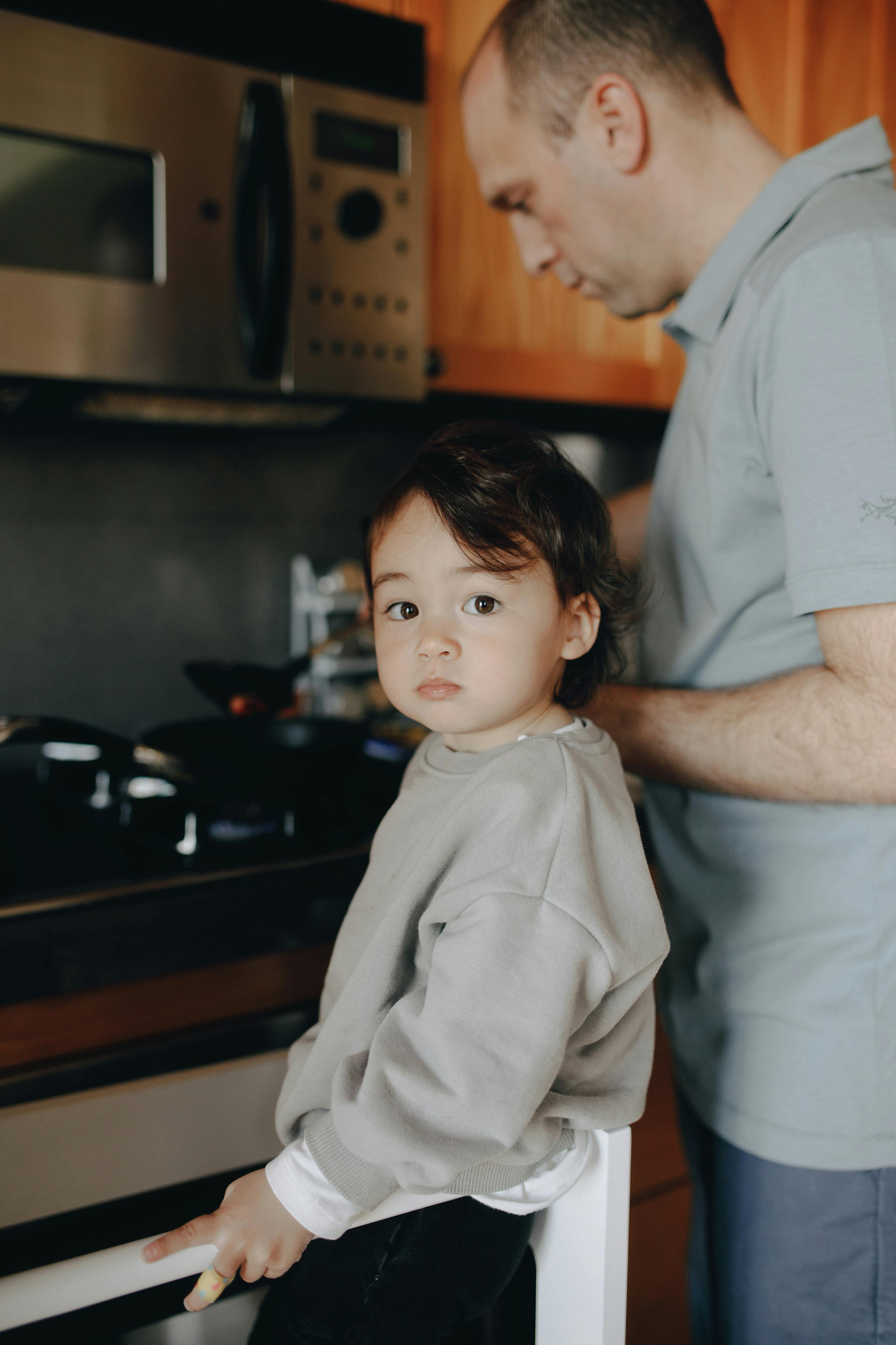 A father and daughter cooking together in their cozy home kitchen, fostering love and bonding.