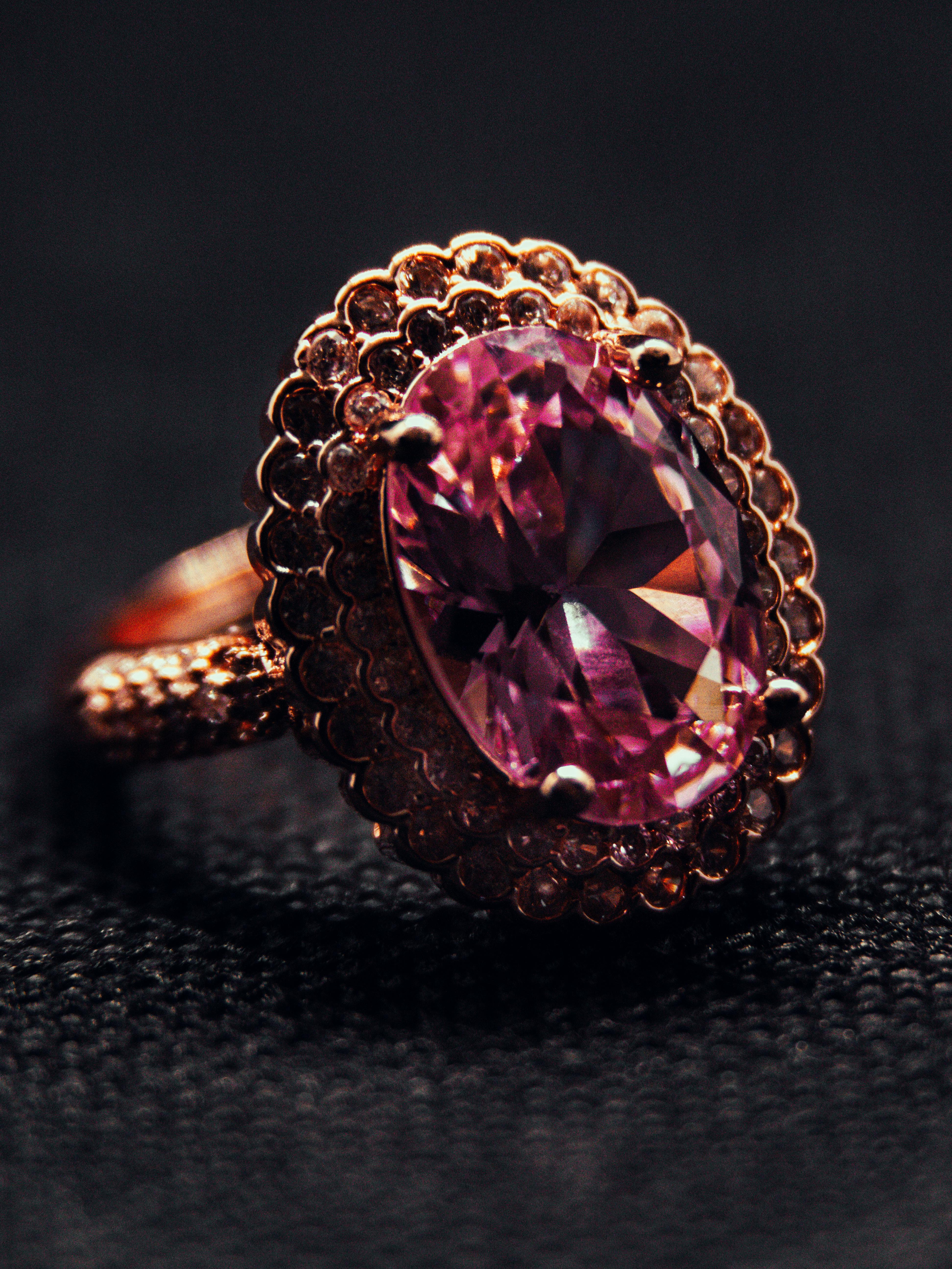 Home Close-up of a luxurious pink gemstone ring set in intricate gold detailing.