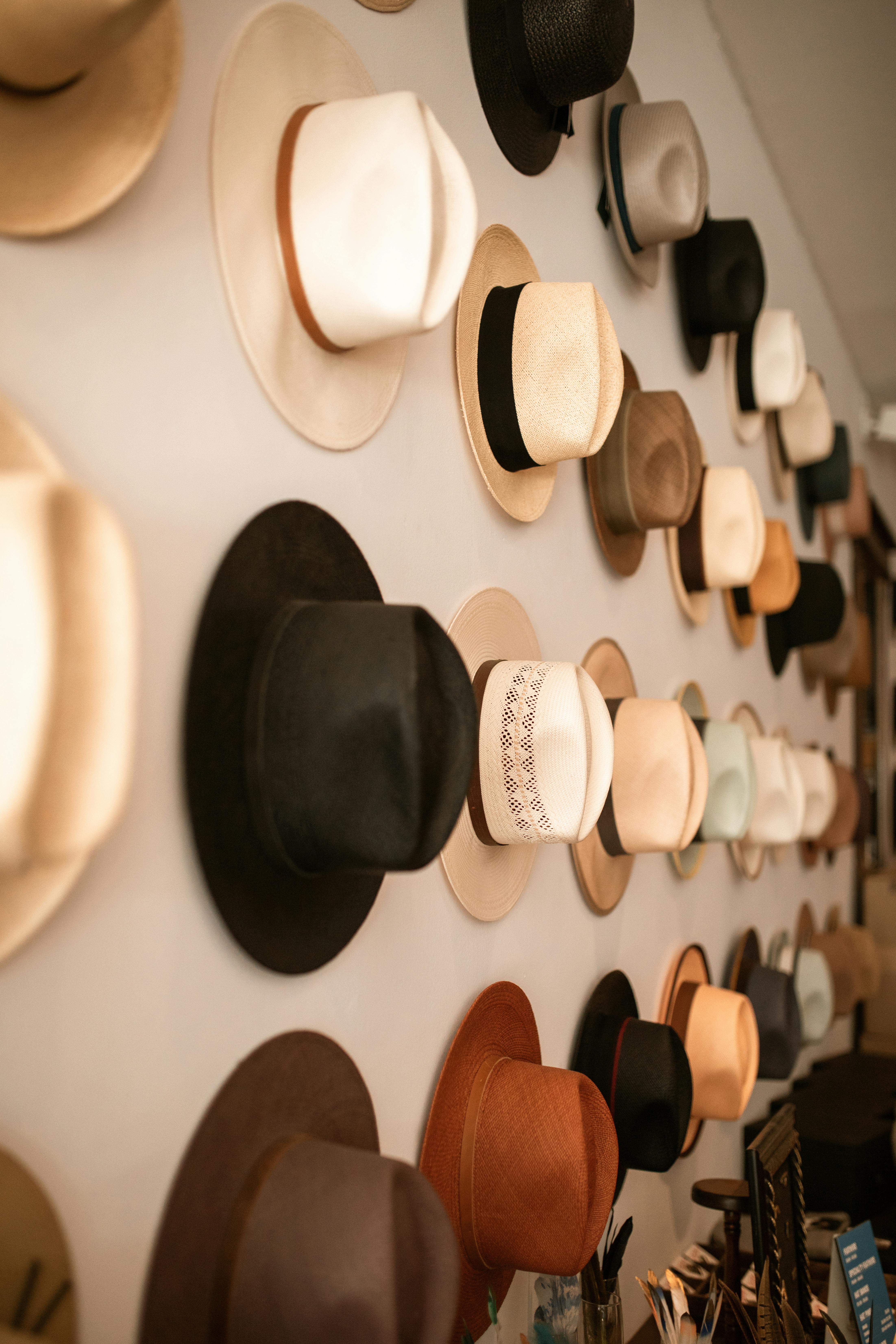 A vibrant collection of various fedora hats hung in a store, showcasing diverse styles and colors.
