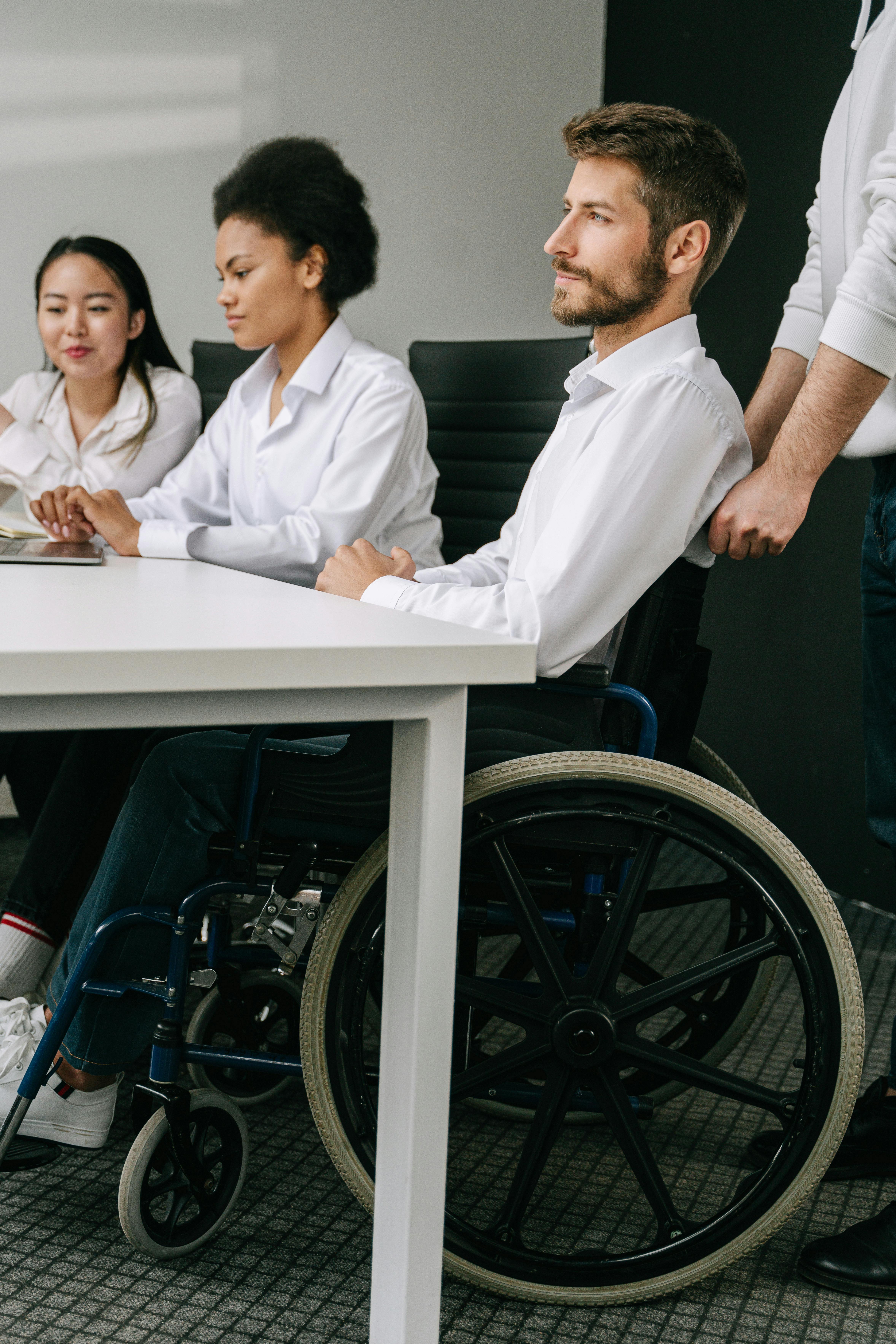 A diverse team collaborates in an office setting, highlighting inclusion and teamwork.