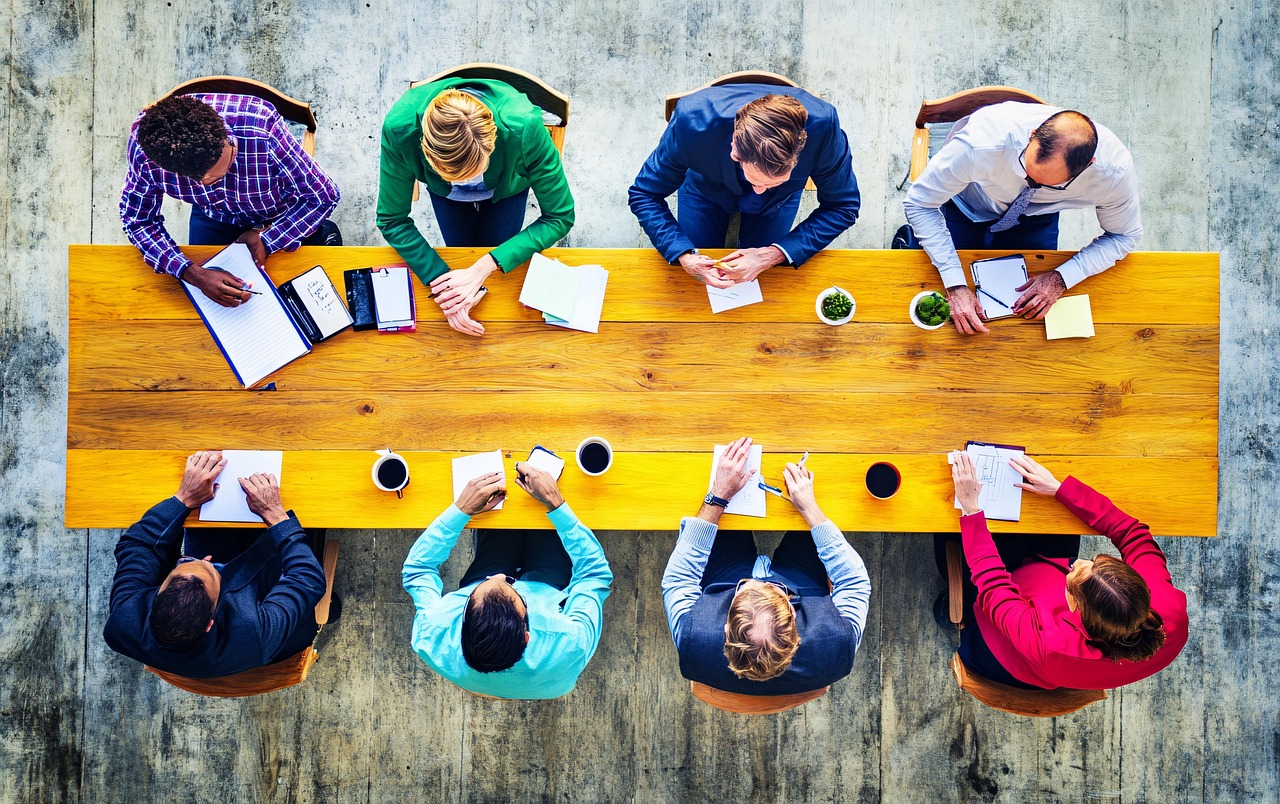 A diverse team collaborates in an office setting, highlighting inclusion and teamwork.